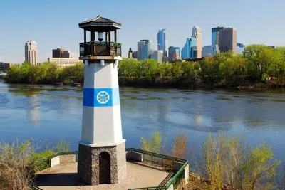 People kayaking on one of Minneapolis's scenic lakes, showcasing the city's abundant outdoor recreation opportunities and natural beauty